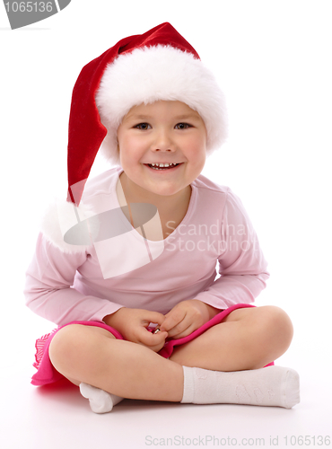 Image of Little girl wearing red Christmas cap