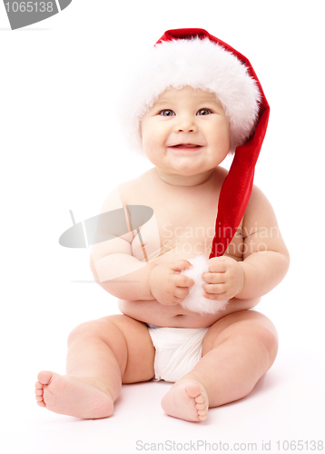 Image of Little child wearing red Christmas cap