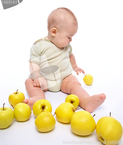 Image of Little boy play with apples