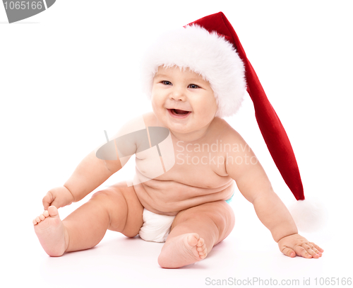 Image of Little child wearing red Christmas cap