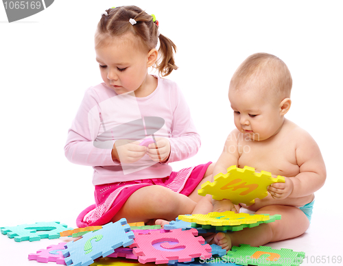 Image of Little boy and girl are playing with alphabet