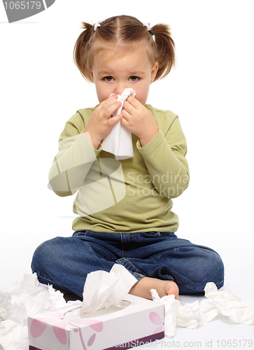 Image of Little girl blows her nose