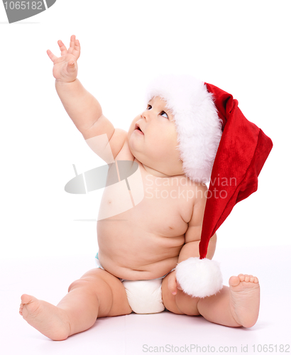 Image of Little child wearing red Christmas cap