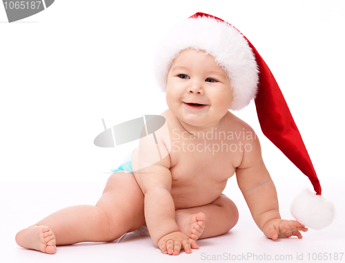 Image of Little child wearing red Christmas cap