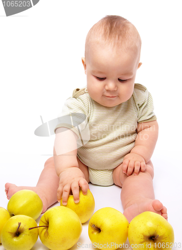 Image of Little boy play with apples