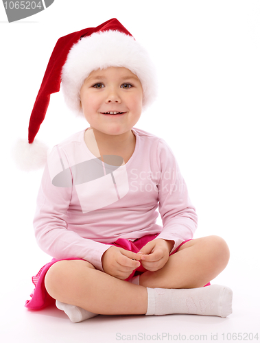 Image of Little girl wearing red Christmas cap