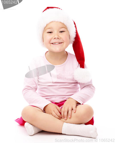 Image of Little girl wearing red Christmas cap