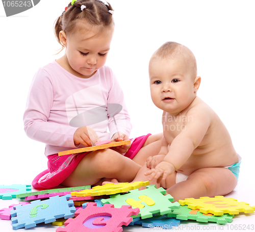 Image of Little boy and girl are playing with alphabet