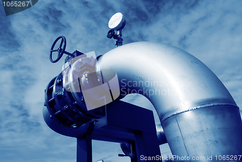 Image of Industrial zone, Steel pipelines and valves against blue sky