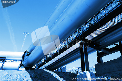 Image of Industrial zone, Steel pipelines and valves against blue sky