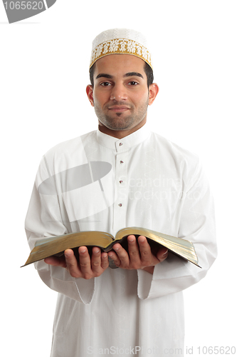 Image of Smiling man holding a book