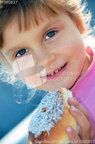 Image of child eating a bun