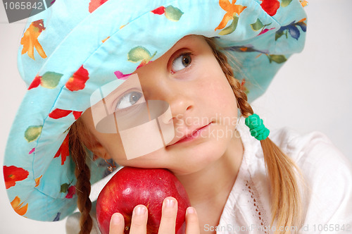 Image of girl with hat and apple