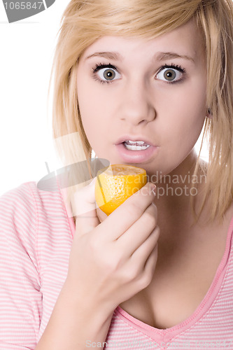 Image of young girl eating lemon