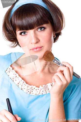 Image of brunet woman with two make-up brushes 