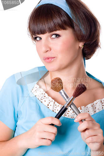 Image of brunet woman with two make-up brushes 