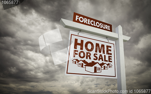Image of White Foreclosure Home For Sale Real Estate Sign Over Cloudy Sky