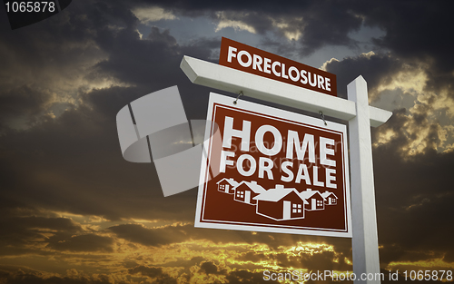 Image of Red Foreclosure Home For Sale Real Estate Sign Over Sunset Sky