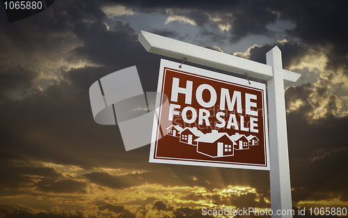 Image of Red Home For Sale Real Estate Sign Over Sunset Sky