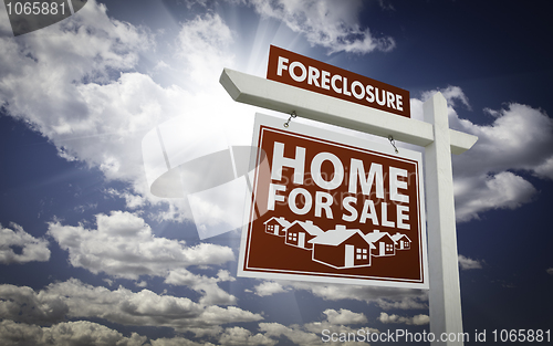 Image of Red Foreclosure Home For Sale Real Estate Sign Over Clouds and S