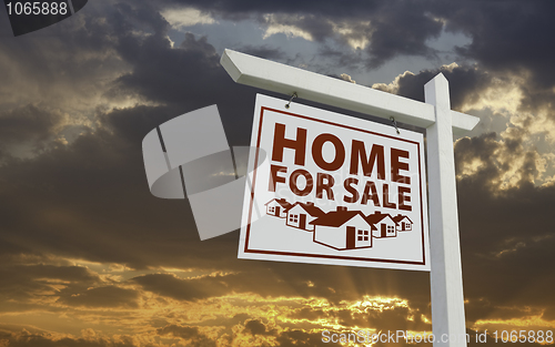 Image of White Home For Sale Real Estate Sign Over Sunset Sky