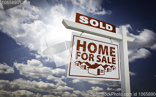 Image of White Sold Home for Sale Real Estate Sign Over Clouds and Sky