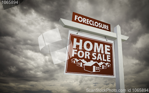 Image of Red Foreclosure Home For Sale Real Estate Sign Over Cloudy Sky