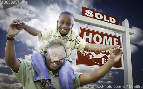 Image of African American Father with Son In Front of Sold Home For Sale 