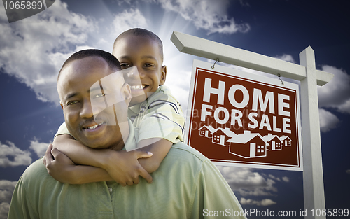Image of African American Father with Son In Front of Real Estate Sign