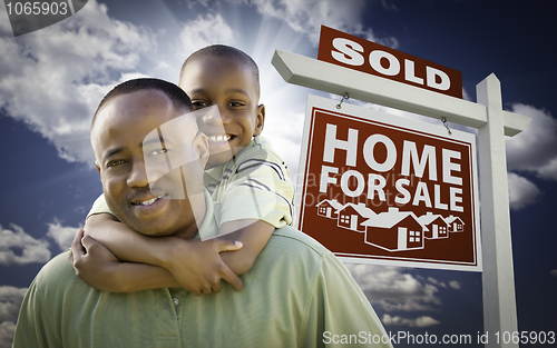 Image of African American Father with Son In Front of Sold Home For Sale 