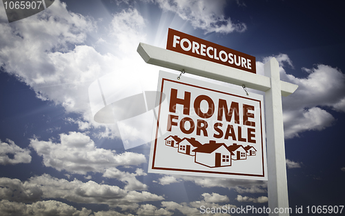 Image of White Foreclosure Home For Sale Real Estate Sign Over Clouds and