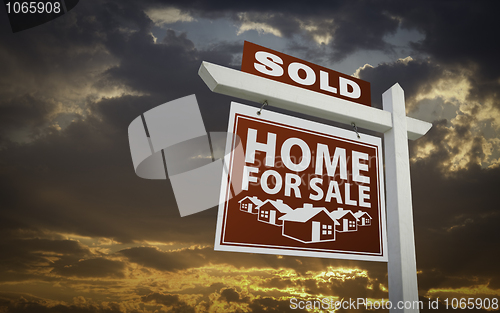 Image of Red Sold Home For Sale Real Estate Sign Over Sunset Sky