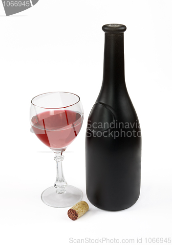 Image of Red wine bottle, glass of wine and stopper