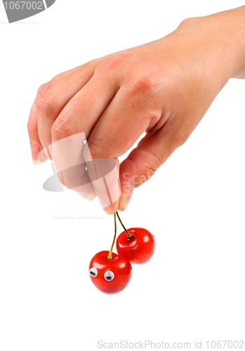 Image of Hand holding two sweet cherry