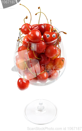 Image of The glass filled by a sweet cherry