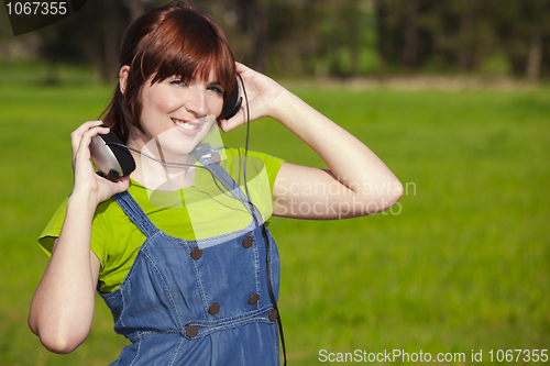 Image of Happy woman listen music