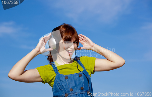 Image of Happy woman listen music