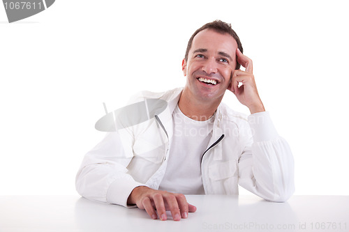 Image of smiling middle-age man sitting at desk 