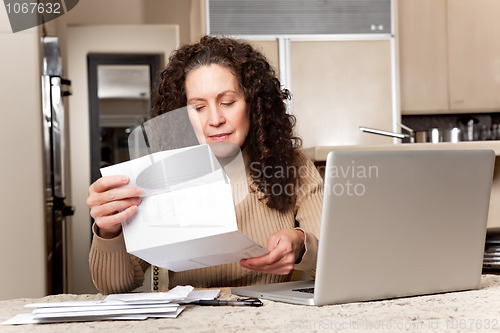 Image of Woman paying bills