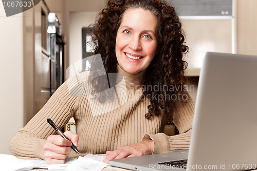 Image of Woman paying bills