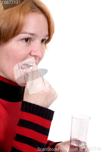 Image of Girl with tablets and a glass