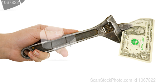 Image of Wrench in a hand with dollar