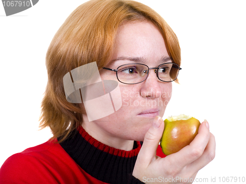 Image of The girl eats an green apple