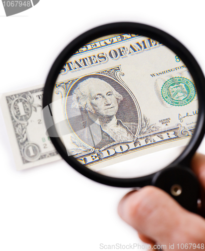 Image of Counterfeit dollar on magnifier