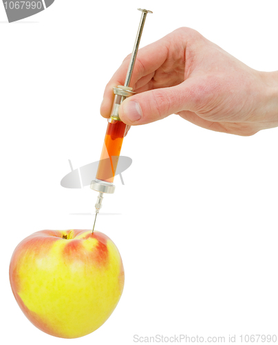 Image of Hand with a syringe and apple