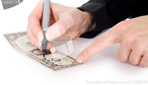 Image of Male hand draw nil on dollar 