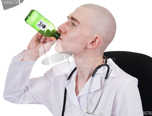 Image of Man in doctor's smock with green bottle