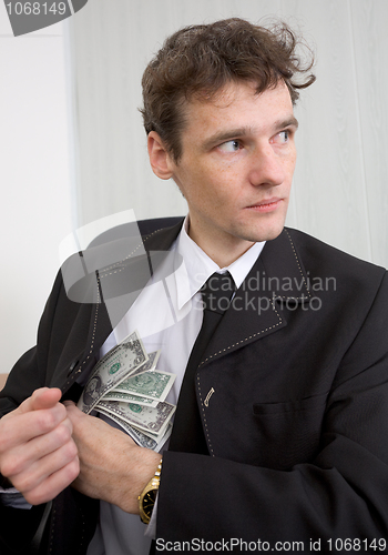 Image of The man hides money