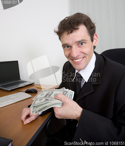 Image of The man holds dollars