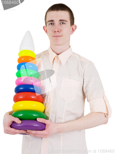 Image of Young man and toy pyramid
